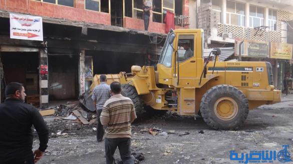 بالصور : بلدية الشطرة ترفع 1250 طنا من انقاض حريق سوق الخان