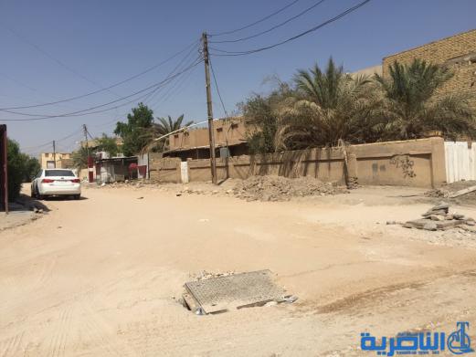 بالصور : اعمال الاكساء تتواصل في شارع بغداد وعدد من احياء الناصرية