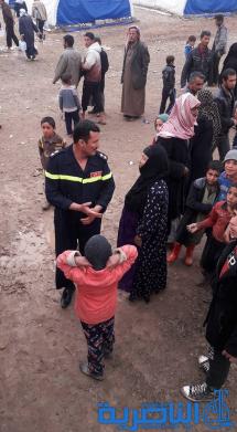 بالصور: الدفاع المدني في ذي قار يرسل مساعدات انسانية لنازحي الموصل