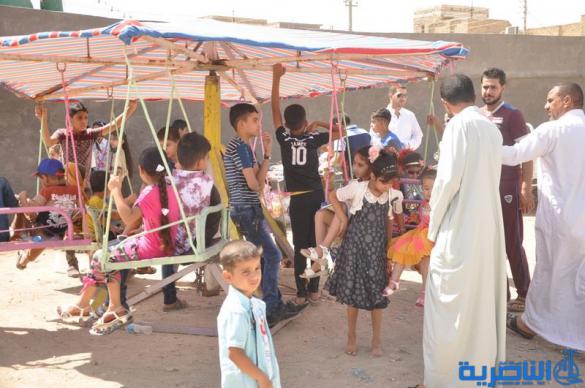 بالصور:اطفال ذوي الدخل المحدود في الناصرية يقضون ايام عيد الفطر بساحات خاوية