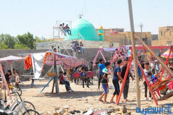 بالصور:اطفال الناصرية يقضون اول ايام عيد الفطر بالساحات والمتنزهات العامة