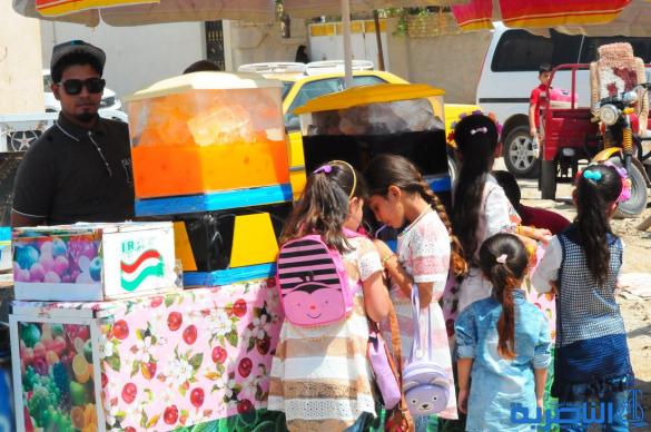 بالصور:اطفال الناصرية يقضون اول ايام عيد الفطر بالساحات والمتنزهات العامة