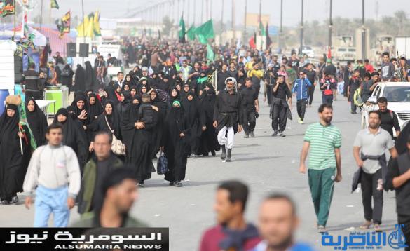  بالصور.. يدٌ تطعم وأخرى تحمي الزائرين الوافدين على كربلاء