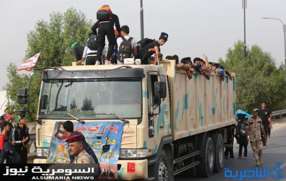  بالصور.. يدٌ تطعم وأخرى تحمي الزائرين الوافدين على كربلاء