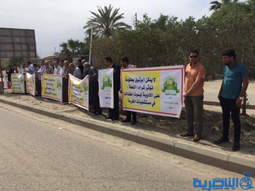 العشرات يتظاهرون في الناصرية للمطالبة بتخفيض اجور الكهرباء - تقرير مصور -