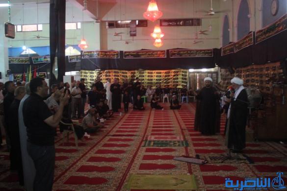 بالصور:موكب جمعية التضامن الاسلامي يحيي ليلة الحادي عشر من المحرم بمسيرة من الشموع