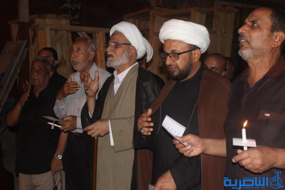 بالصور:موكب جمعية التضامن الاسلامي يحيي ليلة الحادي عشر من المحرم بمسيرة من الشموع