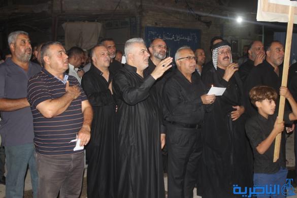 بالصور:موكب جمعية التضامن الاسلامي يحيي ليلة الحادي عشر من المحرم بمسيرة من الشموع