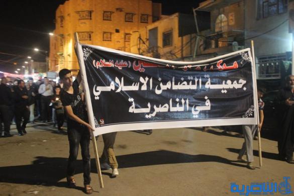 بالصور:موكب جمعية التضامن الاسلامي يحيي ليلة الحادي عشر من المحرم بمسيرة من الشموع