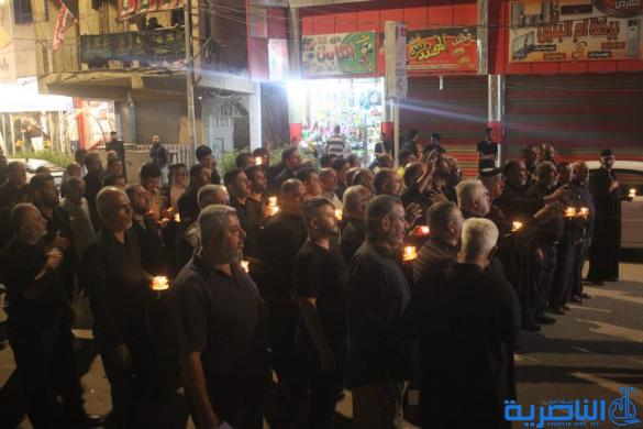 بالصور:موكب جمعية التضامن الاسلامي يحيي ليلة الحادي عشر من المحرم بمسيرة من الشموع
