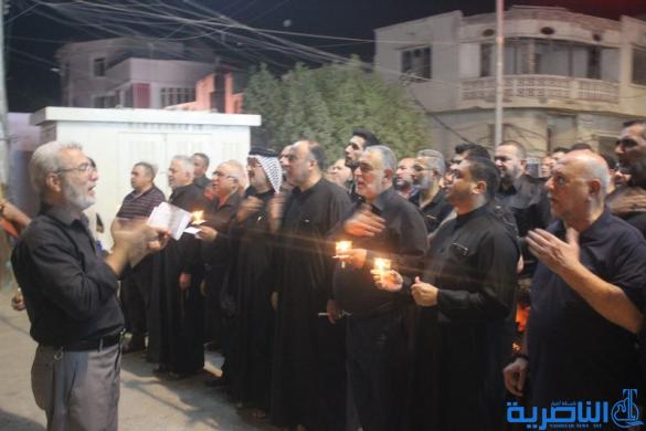 بالصور:موكب جمعية التضامن الاسلامي يحيي ليلة الحادي عشر من المحرم بمسيرة من الشموع