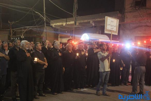 بالصور:موكب جمعية التضامن الاسلامي يحيي ليلة الحادي عشر من المحرم بمسيرة من الشموع