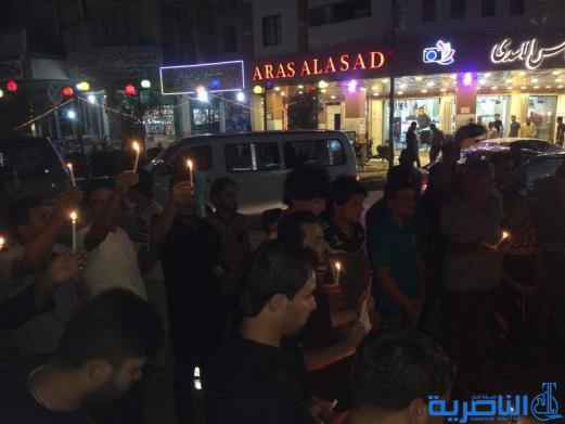 بالصور: الناصرية توقد الشموع حزنا على شهداء الكرادة
