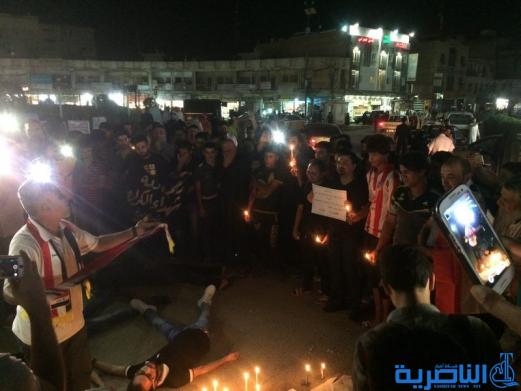 بالصور: الناصرية توقد الشموع حزنا على شهداء الكرادة