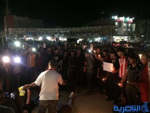 بالصور: الناصرية توقد الشموع حزنا على شهداء الكرادة