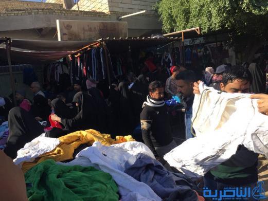 بالصور : سوق البالة يكسو فقراء الناصرية بدفيء الملابس ورخيصها ، والصحة تحذر