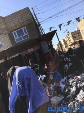 بالصور : سوق البالة يكسو فقراء الناصرية بدفيء الملابس ورخيصها ، والصحة تحذر