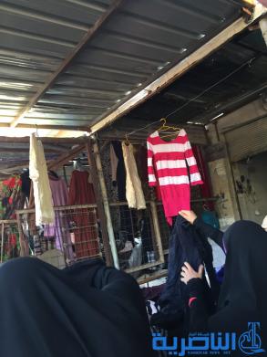 بالصور : سوق البالة يكسو فقراء الناصرية بدفيء الملابس ورخيصها ، والصحة تحذر