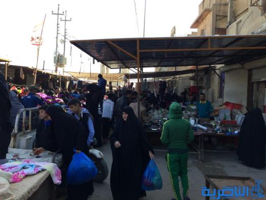 بالصور : سوق البالة يكسو فقراء الناصرية بدفيء الملابس ورخيصها ، والصحة تحذر