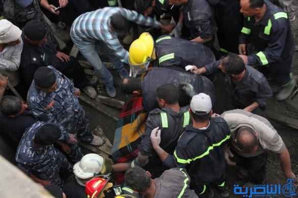 الدفاع المدني ينتشل جثتي عاملي البناء من تحت انفاض المجلس البلدي في الناصرية - تقرير مصور - 