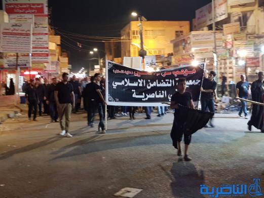بالصور:موكب جمعية التضامن الاسلامي يحيي ليلة الحادي عشر من المحرم بمسيرة من الشموع